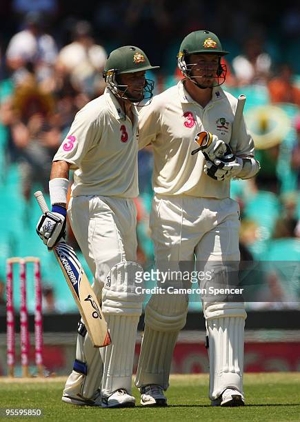 Michael Hussey and Peter Siddle of Australia embrace at the conclusion of the first session during day four of the Second Test between Australia and...