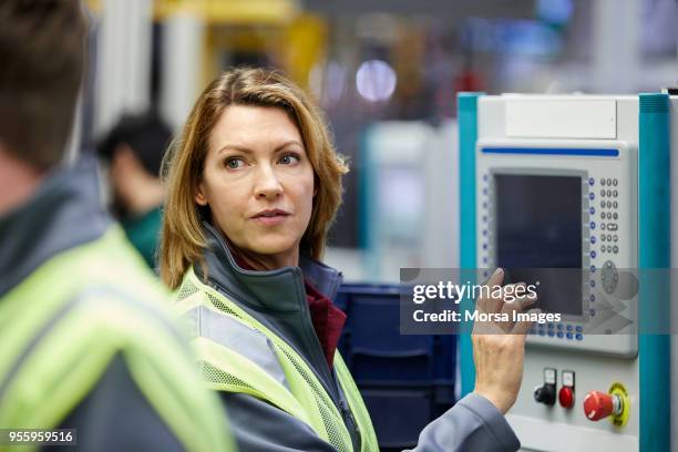 female engineer using control panel in car plant - screen protector stock pictures, royalty-free photos & images