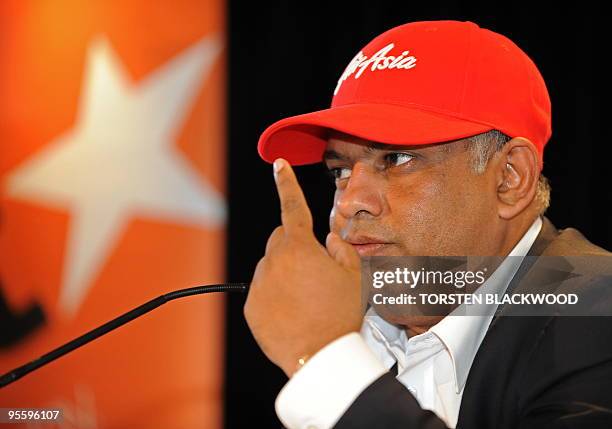 AirAsia CEO Tony Fernandes gestures while announcing plans to slash costs and ticket prices by pooling with Australia's JetStar during a press...