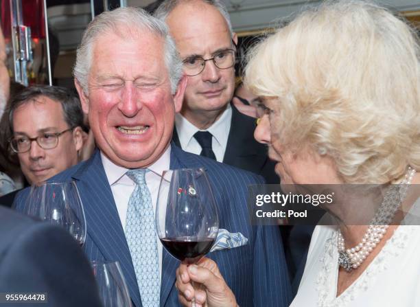 Prince Charles, Prince of Wales and Camilla, Duchess of Cornwall drink wine as they visit Les Halles de Lyon-Paul Bocuse food market on May 8, 2018...