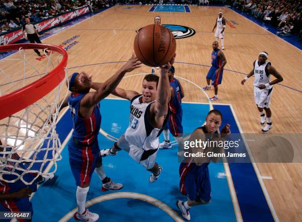 Kris Humphries of the Dallas Mavericks goes up for the layup against Charlie Villanueva of the Detroit Pistons during a game at the American Airlines...