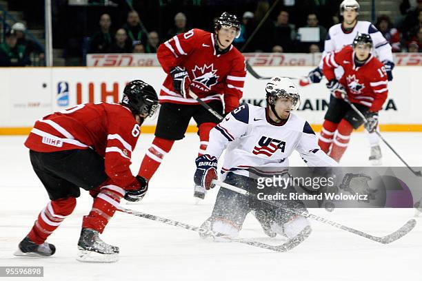 David Warsofsky of Team USA reaches for the puck in front of Ryan Ellis of Team Canada during the 2010 IIHF World Junior Championship Tournament Gold...