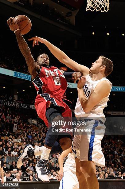 Terrence Williams of the New Jersey Nets goes to the basket against Rasho Nesterovic of the Toronto Raptors during the game on December 18, 2009 at...