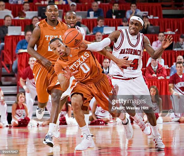 Stef Welsh of the Arkansas Razorbacks goes for a steal against Avery Bradley of the Texas Longhorns at Bud Walton Arena on January 5, 2010 in...