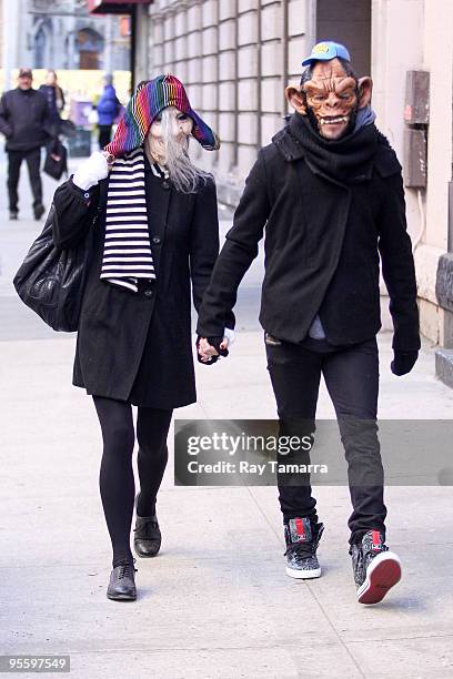 Singer Ashlee Simpson Wentz and musician Pete Wentz wear masks as they walk in Manhattan on January 5, 2010 in New York City.