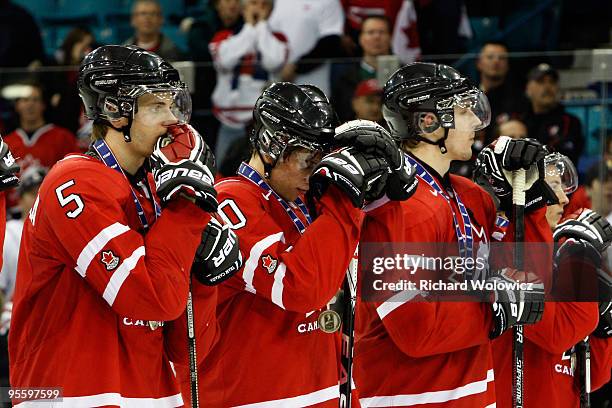 Marco Scandella, Brayden Schenn and Colten Teubert watch post game ceremonies after being defeated by Team USA 6-5 in overtime at the 2010 IIHF World...