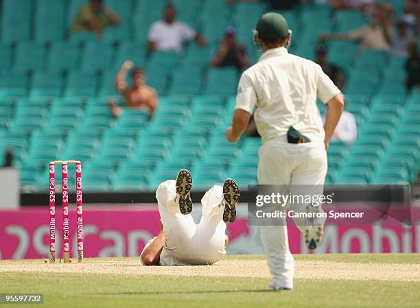 Nathan Hauritz of Australia lies on the ground injured after dismissing Mohammad Yousuf of Pakistan caught and bowled during day four of the Second...