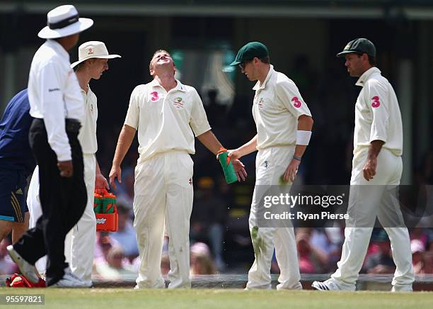 Nathan Hauritz of Australia is treated for a finger injury after he took the wicket of Mohammad Yousuf of Pakistan during day four of the Second Test...