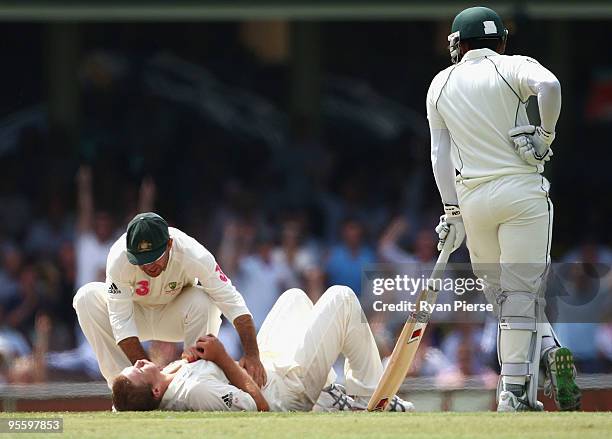 Ricky Ponting of Australia rushes to the aid of an injured Nathan Hauritz of Australia after he took the wicket of Mohammad Yousuf of Pakistan during...