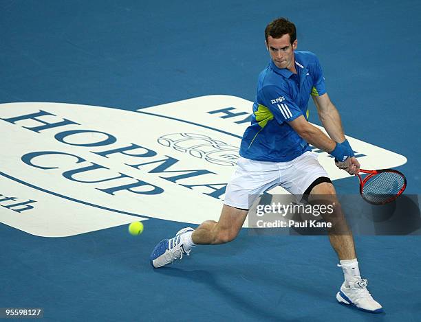 Andy Murray of Great Britain plays a backhand shot in his match against Philipp Kohlschreiber of Germany in the Group B match between Great Britain...