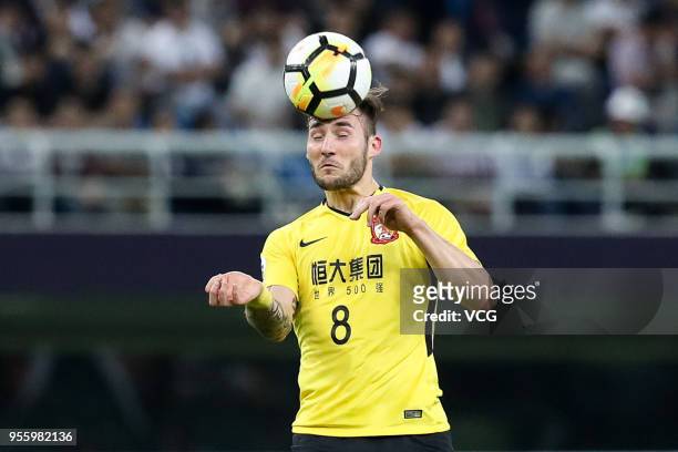 Nemanja Gudelj of Guangzhou Evergrande heads the ball during the AFC Champions League Round of 16 first leg match between Tianjin Quanjian and...