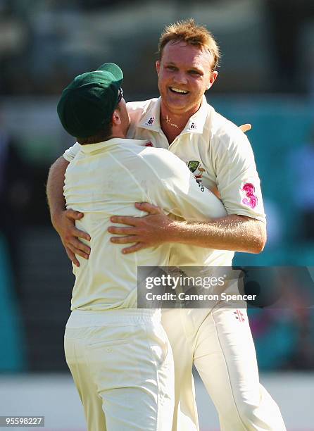 Doug Bollinger of Australia is congratulated by team mate Peter Siddle after dismissing Umar Akmal of Pakistan during day four of the Second Test...