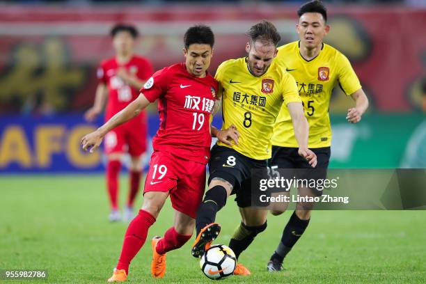 Wang Xiaolong of Tianjin Quanjian competes the ball with Nemanja Gudelj of Guangzhou Evergrande during the AFC Champions League Round of 16 first leg...