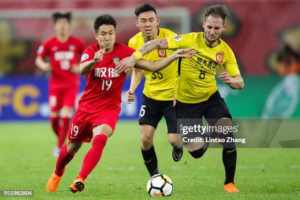 Wang Xiaolong of Tianjin Quanjian competes the ball with Nemanja Gudelj of Guangzhou Evergrande during the AFC Champions League Round of 16 first leg...