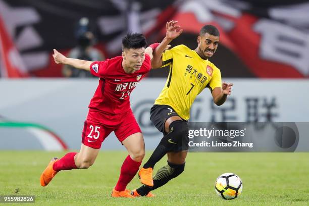 Mi Haolun of Tianjin Quanjian competes the ball with Alan of Guangzhou Evergrande during the AFC Champions League Round of 16 first leg match between...