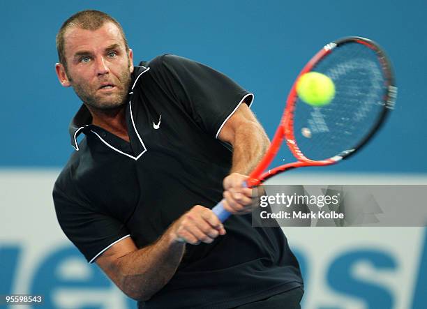 Marc Gicquel of France plays a backhand in his second round match against James Blake of the USA during day four of the Brisbane International 2010...