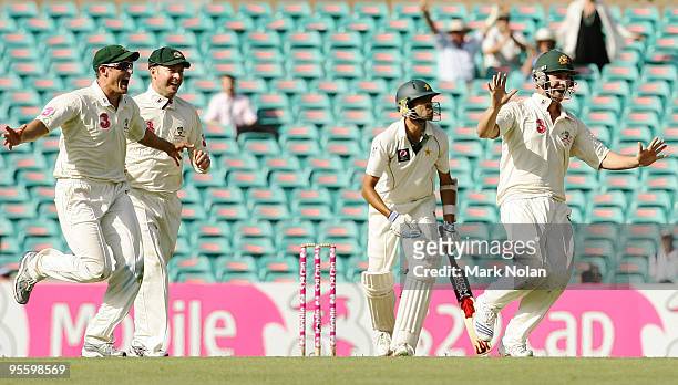 Michael Hussey, Michael Clarke and Phillip Hughes of Australia celebrate victory during day four of the Second Test match between Australia and...