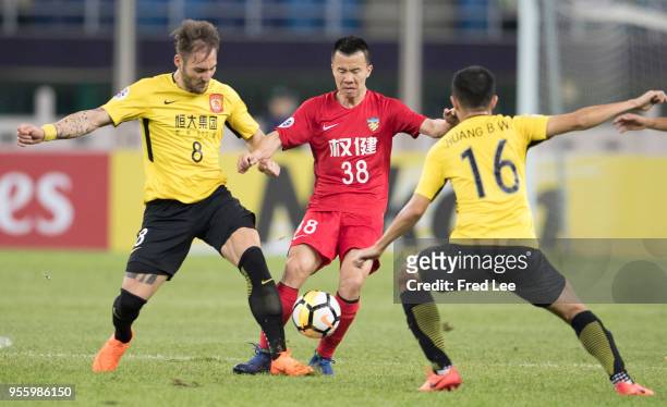 Nemanja Gudelj of Guangzhou Evergrande and Sun Ke of Tianjin Quanjian in action during the AFC Champions League Round of 16 first leg match between...