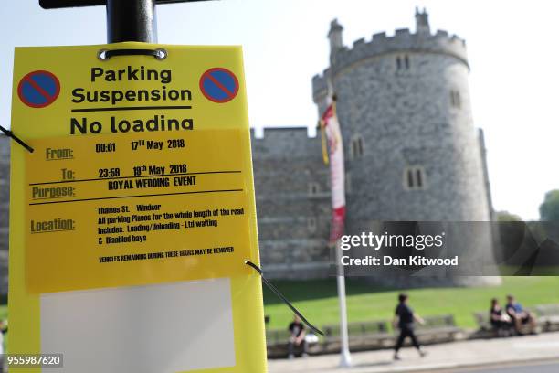 Parking suspension signs hang Windsor Castle as the town prepares for the wedding of Prince Harry and his fiance US actress Meghan Markle, on May 8,...