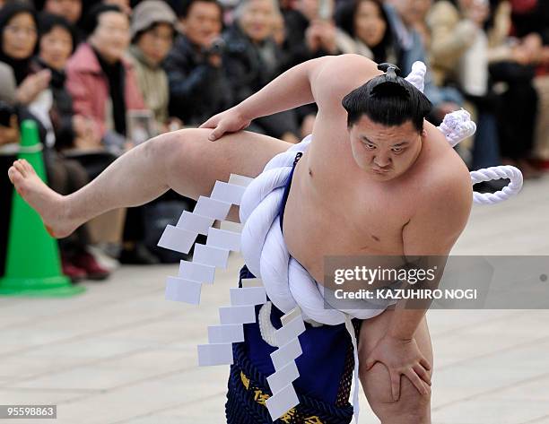 Mongolian-born 'yokozuna', or sumo grand champion, Hakuho demonstrates a ceremonial performance to mark the new year at Meiji Shrine in Tokyo on...