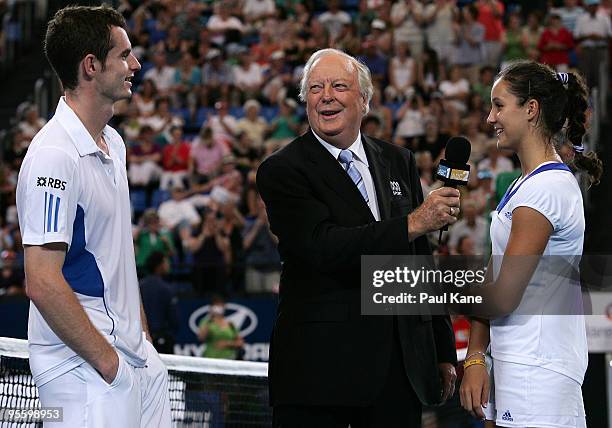 Fred Stole talks with Andy Murray and Laura Robson of Great Britain after the mixed doubles match against Philipp Kohlschreiber and Sabine Lisicki of...