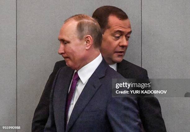 Russia's President Vladimir Putin and acting Prime Minister Dmitry Medvedev attend a session of the State Duma in Moscow on May 8, 2018. - The...