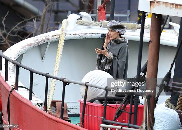Angelina Jolie takes a break from filming on location for "Salt" on a boat in the Hudson River on December 28, 2009 in New York City.