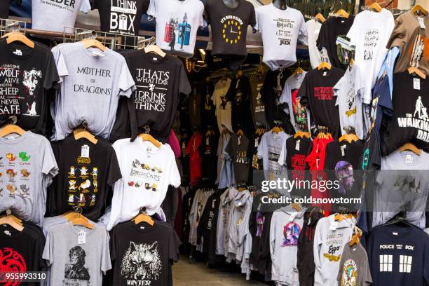 t-shirt display on covent garden market stall, london, uk - t shirtvendor stock pictures, royalty-free photos & images