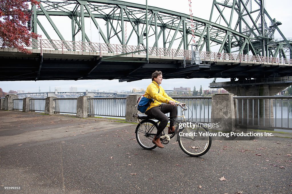 Man commuting to work with bridge behind him