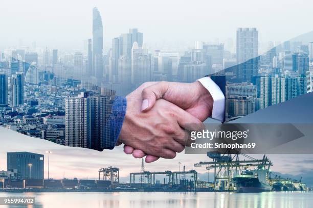 businessmen are shaking hands to agree to a business deal success business of logistics industrial container cargo freight ship for concept - air freight transportation stock pictures, royalty-free photos & images