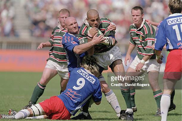 Leon Lloyd of Leicester is tackled by Christophe Moni and Morgan Williams Stade Francais in action during the Heineken Cup Final between Stade...