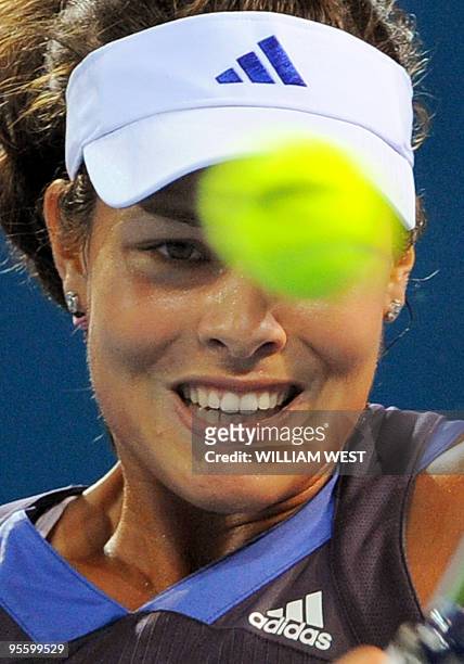 Ana Ivanovic of Serbia keeps an eye on the ball in her match against Timea Bacsinszky of Switzerland at the Brisbane International tennis tournament,...