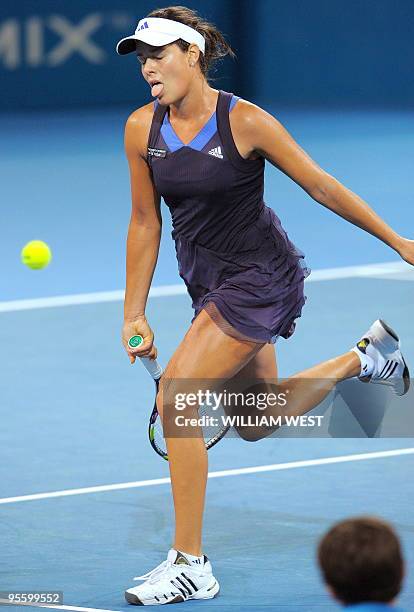 Ana Ivanovic of Serbia reacts as she chases the ball in her match against Timea Bacsinszky of Switzerland at the Brisbane International tennis...