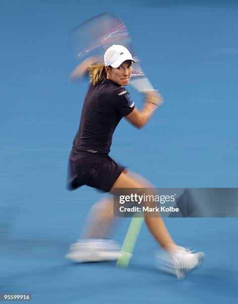 Justine Henin of Belgium plays a backhand in her second round match against Sesil Karatantcheva of Kazakhstan during day four of the Brisbane...