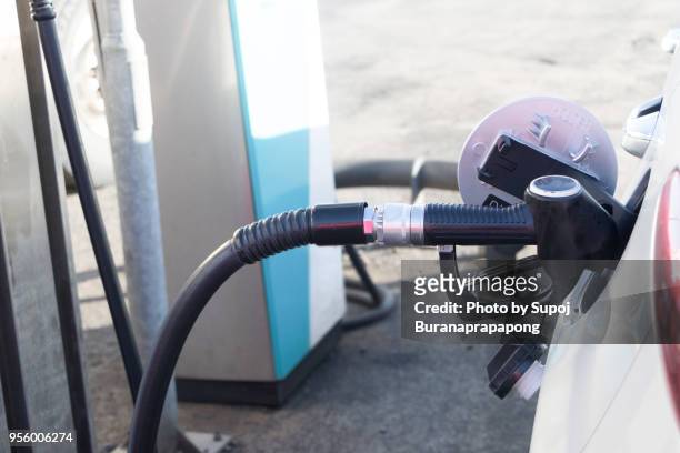 white car being filled with fuel at gas station in vik village,iceland - myrdalur stock pictures, royalty-free photos & images