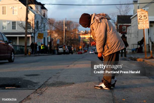 Man who declined to speak with the photographer teeters unsteadily on his feet in the middle of the street near Oxford Street Shelter, left. The pose...