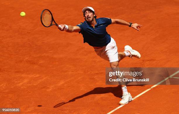 Pablo Cuevas of Argentina stretches to play a forehand against Jack Sock of the United States in their first round match during day four of the Mutua...