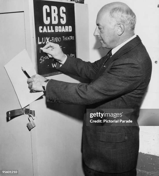 American director Cecil B. DeMille , chalks up the rehearsal time on the call board at CBS radio studios, Hollywood, California, 1943. DeMille is the...