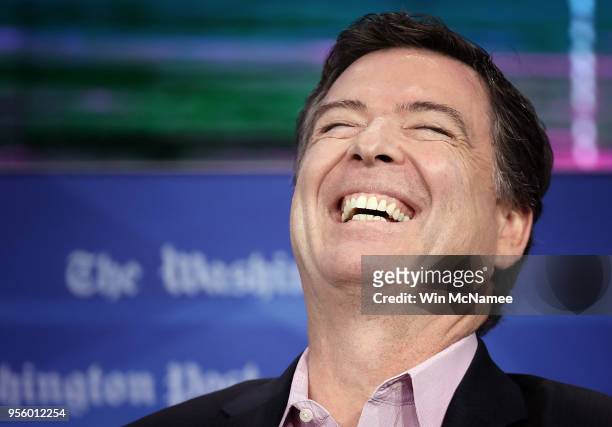 Former FBI director James Comey laughs while answering questions during an interview forum at the Washington Post May 8, 2018 in Washington, DC....