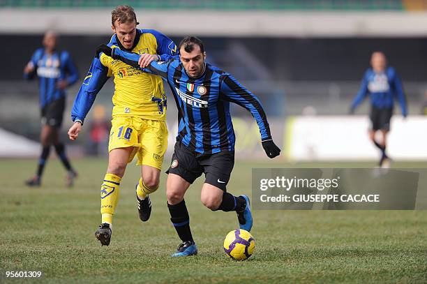 Inter Milan's forward Goran Pandev challenges for the ball with Chievo midfielder Luca Rigoni during their Italian Serie A football match on January...