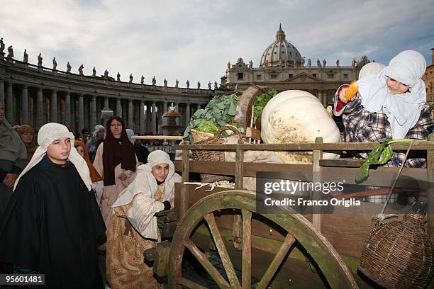 People in costume gather in St Peter's Square for the solemnity of the Epiphany attend the Angelus Blessing held by pope Benedict XVI on January 6,...