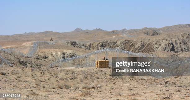 Pakistani army soldier stands guard along with border fence at the Pak-Afghan border near the Punjpai area of Quetta in Balochistan on May 8, 2018. -...