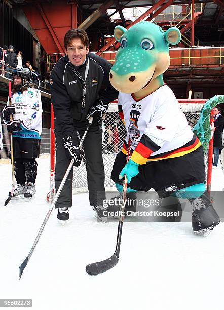 National coach Uwe Krupp of Germany and mascot Urmel pose during a presentation day due to the IIHW World Championships at the Kokerei Zollverein on...