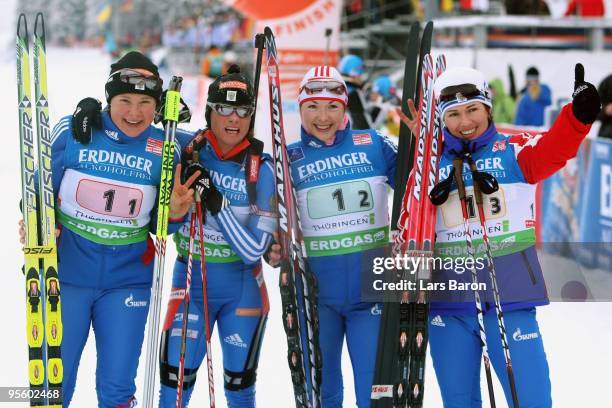 The team of Russia Anna Bogaliy Titovets, Svetlana Sleptsova, Anna Boulygina and Olga Medvedtseva pose after winning the Women's 4 x 6km Relay in the...