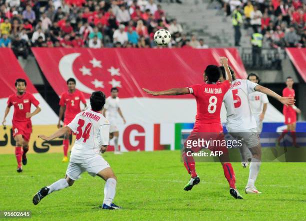 Alam Shah of Singapore fights for the ball with Hosseini Hadi Aghily of Iran during the AFC 2011 Asian Cup qualifying match group E in Singapore on...