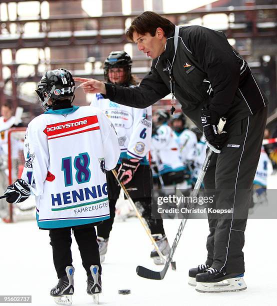 Head coach Uwe krupp of Germany issues instructions to young hockey player during a presentation day due to the IIHW World Championships at the...