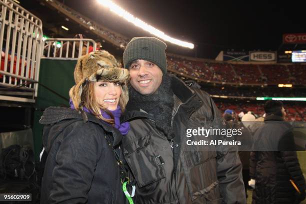 Actor Bobby Cannavale meets with actress Jennifer Esposito on the sidelines when he attends the Cincinnati Bengals vs. New York Jets game at Giants...