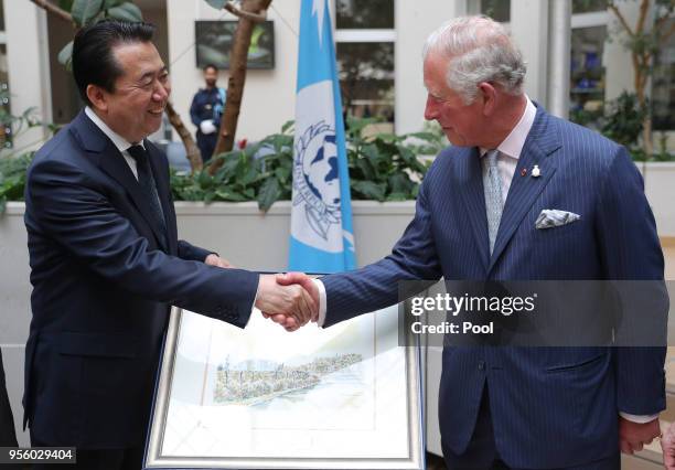 The Prince of Wales shakes hands with Interpol President Meng Hongwei during his tour of Interpol as part of his visit to France on May 8th, 2018 in...