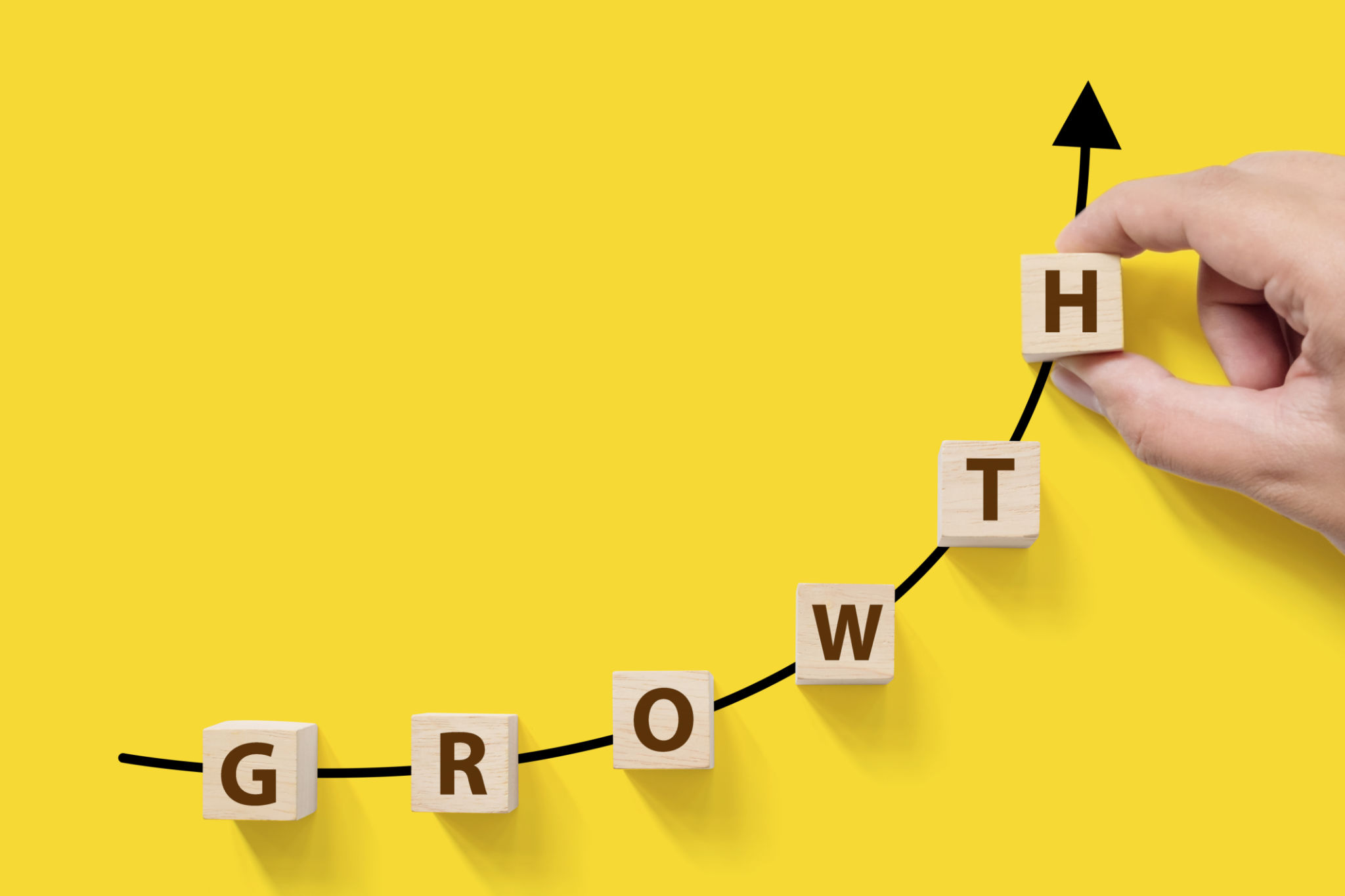 Business success growing growth increase up concept. Wooded cube block on white background with word GROWTH and copy space for your text Business success growing growth increase up concept. Wooded cube block on white background with word GROWTH and copy space for your text