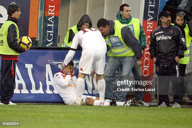 Simone Perrotta struck by a firecracker during the Serie A match between Cagliari and Roma at Stadio Sant'Elia on January 6, 2010 in Cagliari, Italy.